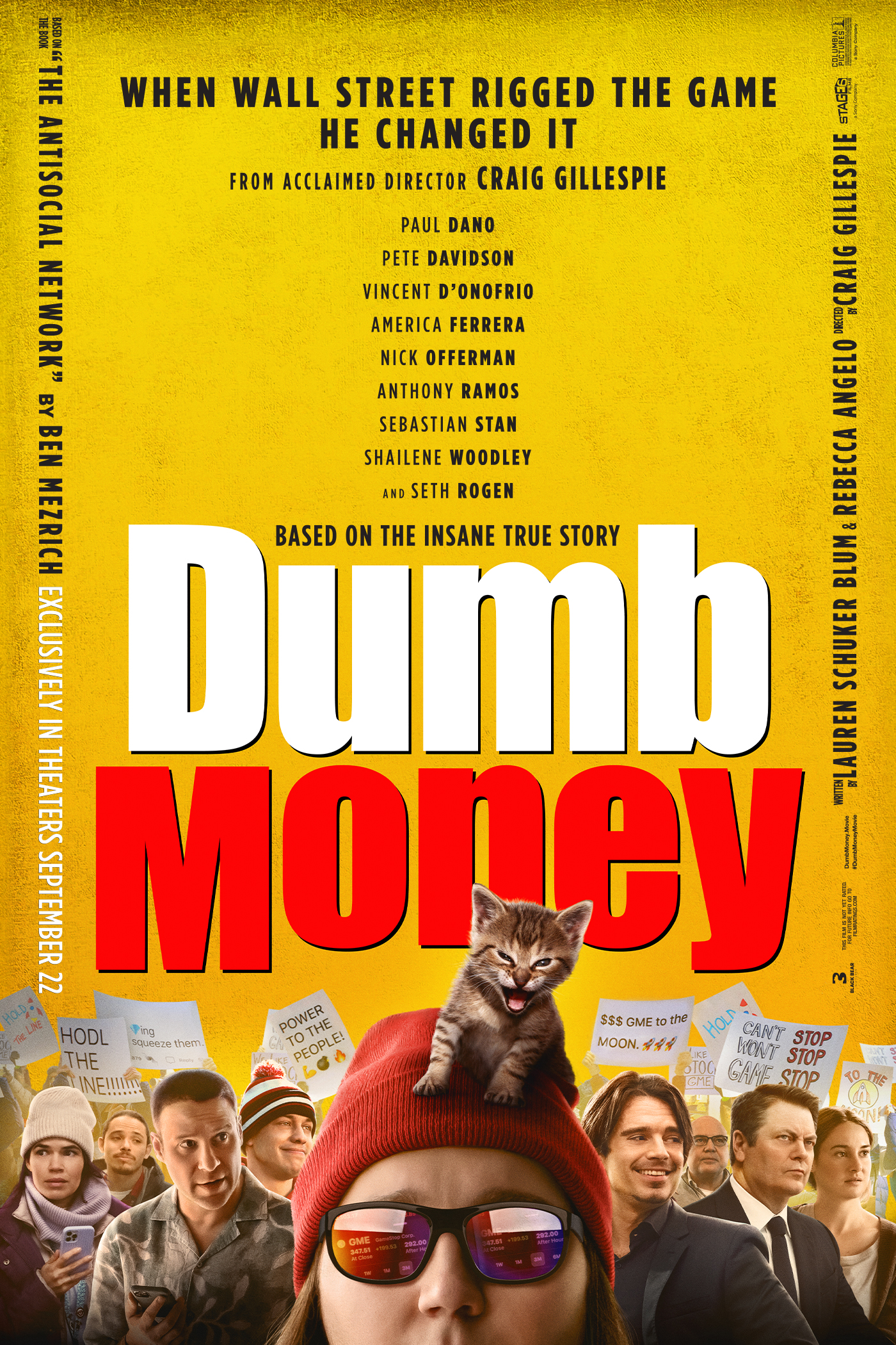 Yellow background with "Dumb Money" in text in the middle. On the bottom shows a line of people with protest signs in the background. In the middle is Paul Dano with sunglasses, a beanie, and a small kitten on his head.