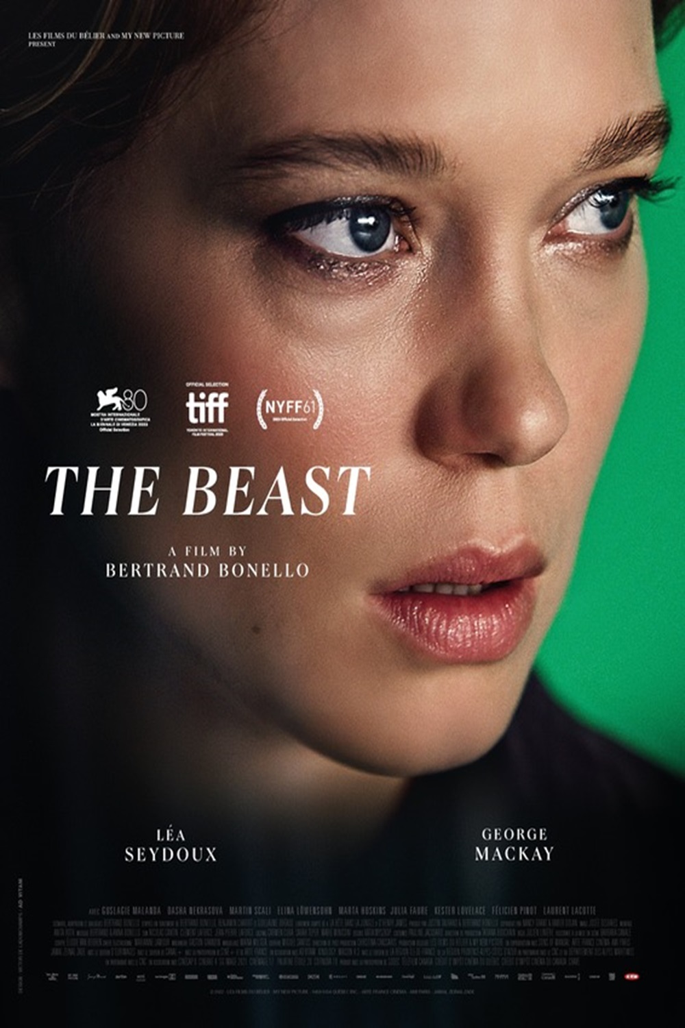 An close up portrait Lea Seydoux, looking intensely to the right in front of a green background. The title THE BEAST is aligned to the left middle of the image.